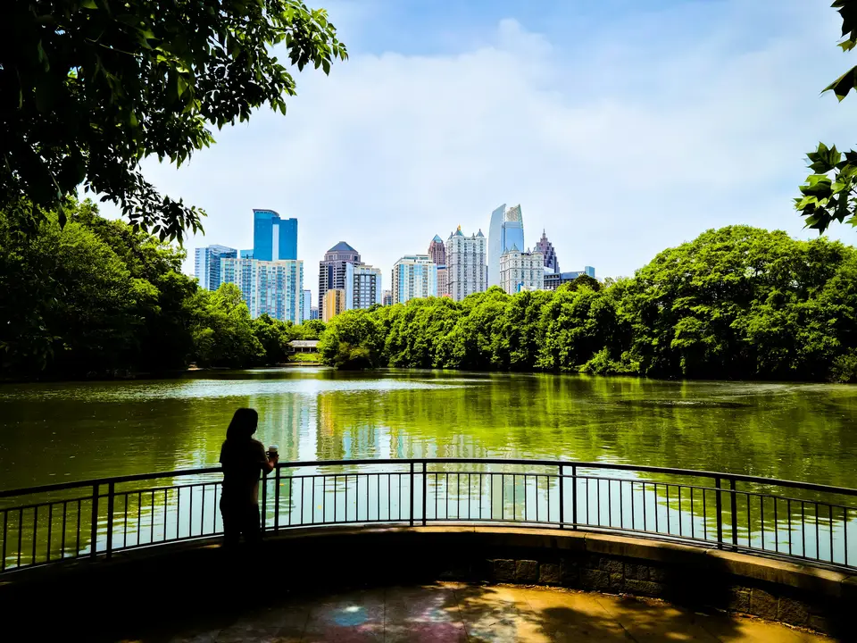 a person standing on a bridge over a river — Atlanta