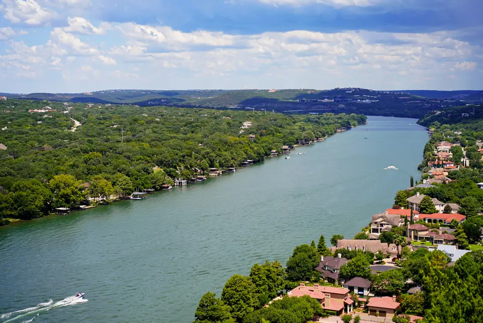 aerial view of green trees near body of water during daytime — Austin