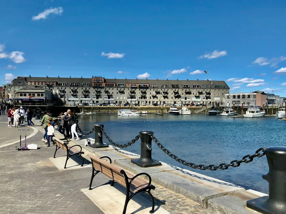 people sitting on bench near body of water during daytime — Boston