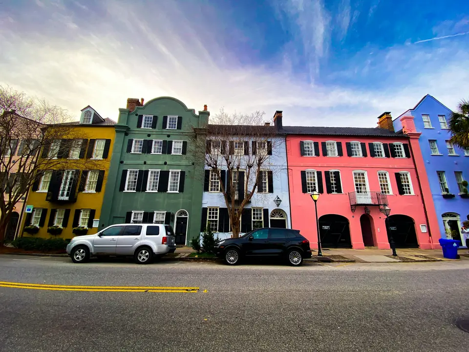 cars parked in front of red building — Charleston