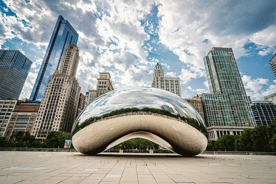 white and blue round structure in front of city buildings during daytime — Chicago