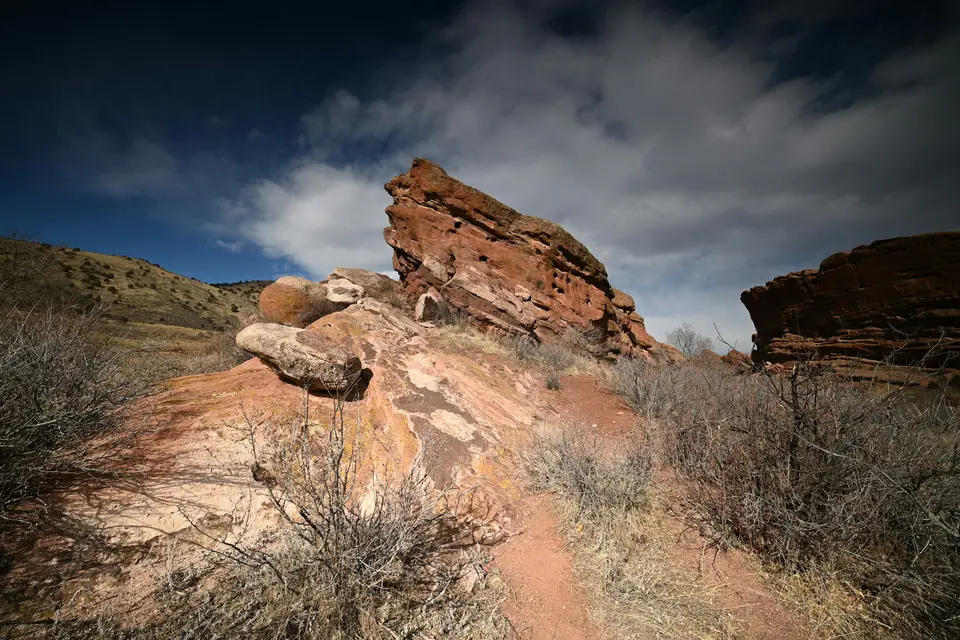 Red rock formations under a cloudy blue sky — Denver