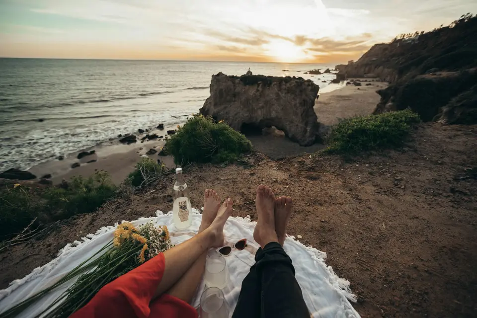 person lying on white textile beside beach — Los Angeles