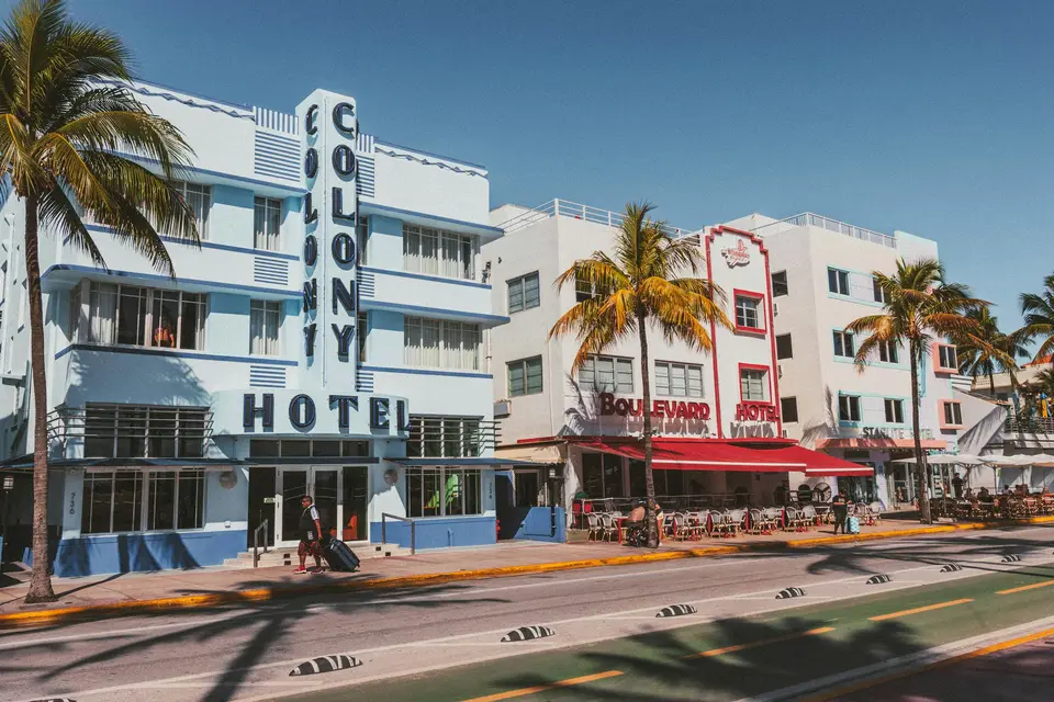 A large white building with palm trees in front of it — Miami