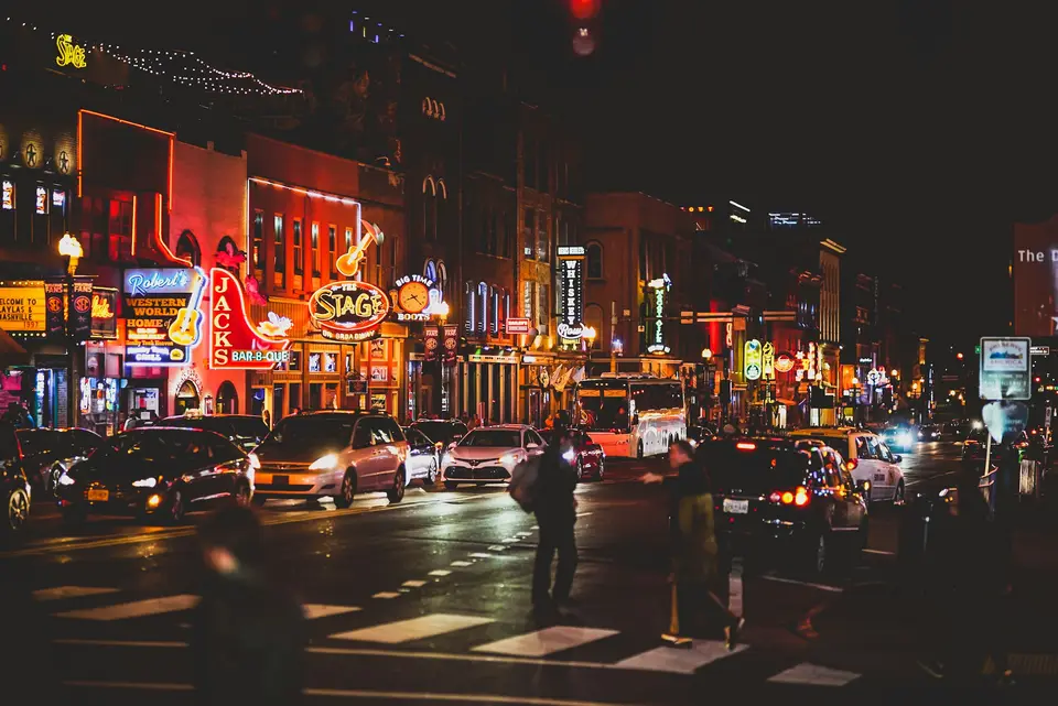 people walking on sidewalk during night time — Nashville