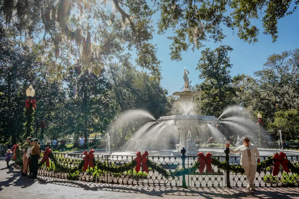 A group of people standing in front of a fountain — Savannah