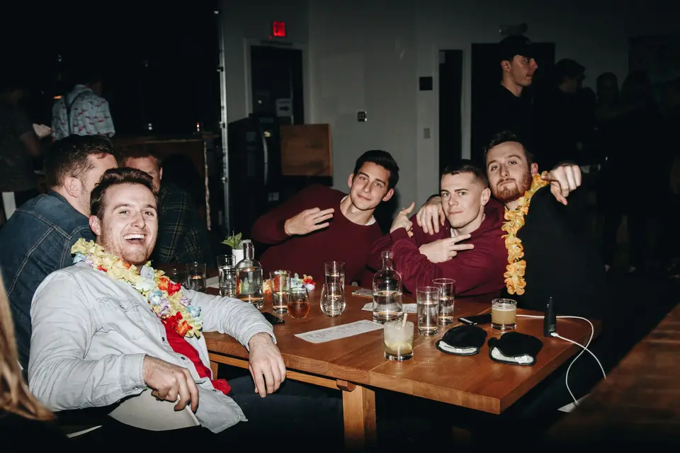 A group of men sitting around a wooden table