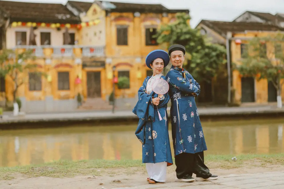 Couple in traditional vietnamese clothing by river